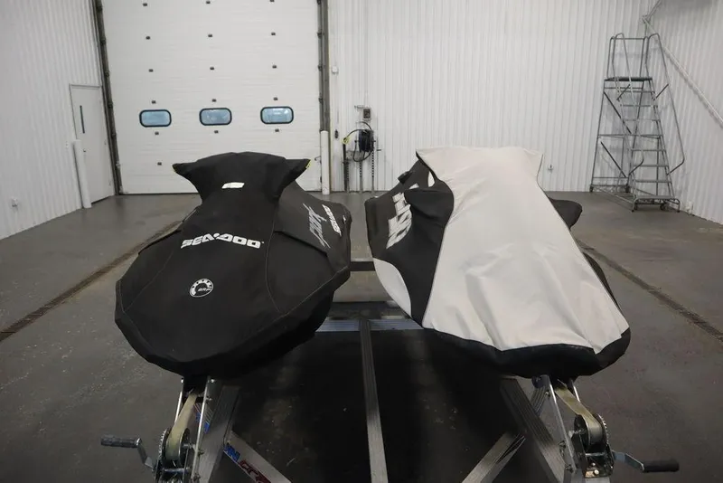 Slide: The Image of Two covered 2015 Sea-Doo Spark for 3 jet skis in a garage. - 39