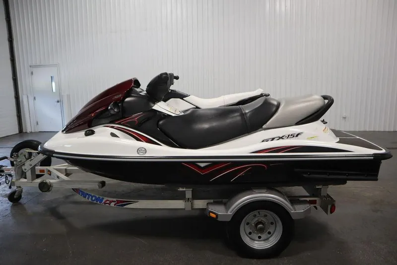 Slide: The Image of 2015 Sea-Doo Spark for 3 jet ski on trailer in indoor setting. - 8