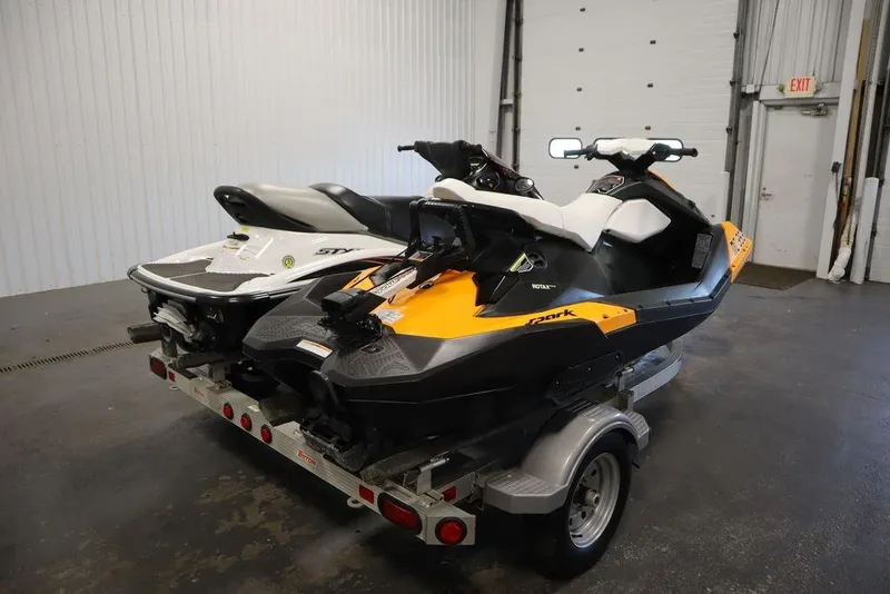 Slide: The Image of 2015 Sea-Doo Spark for 3 jet ski on trailer in garage setting. - 9