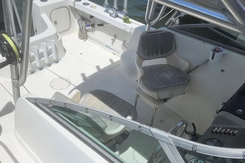 Slide: The Image of 2002 Bayliner Trophy Walkaround boat interior with seating and fishing rod holders. - 6