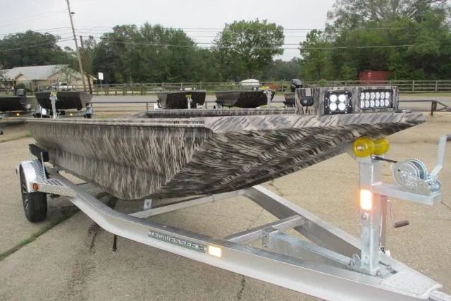 Slide: The Image of 2026 Reaper Boats 753-1688 on trailer, featuring camouflage design and LED lights. - 2