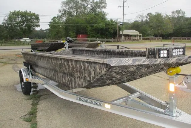 Slide: The Image of 2026 Reaper Boats 753-1688 on trailer, camo design, parked outdoors. - 5
