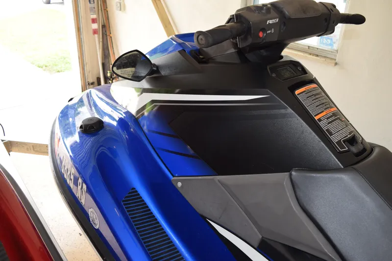 Slide: The Image of 2018 Yamaha WaveRunner EX Deluxe in a garage, showcasing sleek blue and black design. - 6