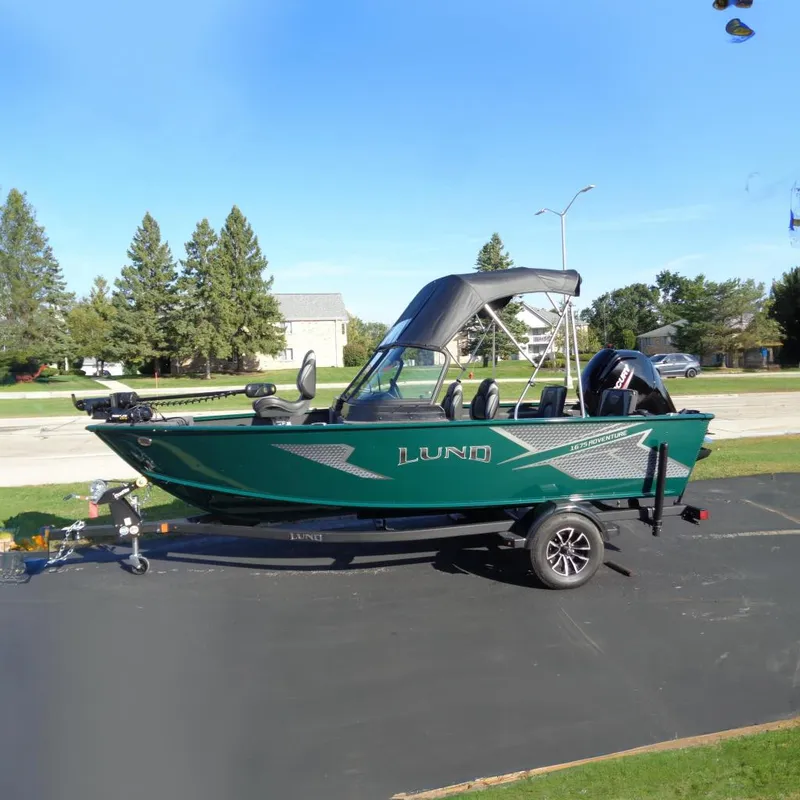 The Image of 2026 Lund 1675 Adventure Sport boat on trailer, parked outdoors. - 0