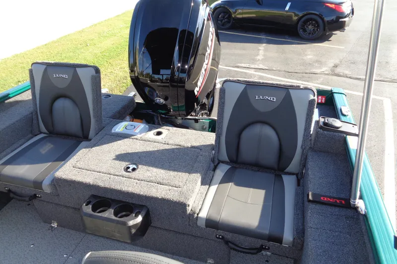 Slide: The Image of 2026 Lund 1675 Adventure Sport boat interior with Mercury engine, featuring comfortable seating. - 15