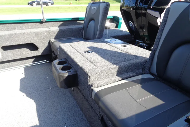 Slide: The Image of 2026 Lund 1675 Adventure Sport boat interior with cushioned seating and cup holders. - 16