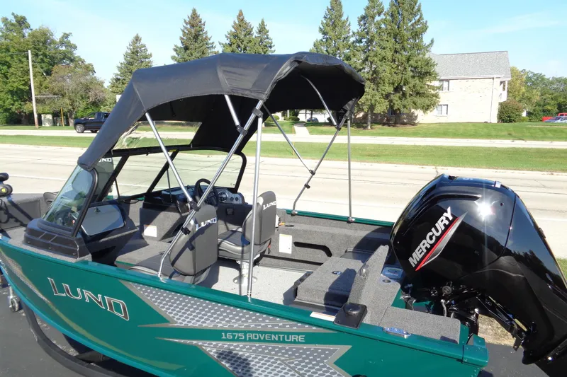 Slide: The Image of 2026 Lund 1675 Adventure Sport boat with Mercury engine, parked outdoors. - 21