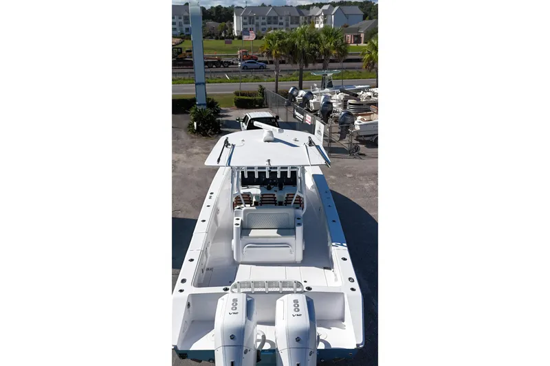 Slide: The Image of 2023 Jupiter 40 boat with dual engines, docked near a marina. - 10