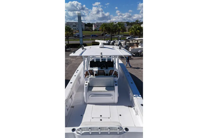 Slide: The Image of 2023 Jupiter 40 boat with sleek design, spacious deck, and modern seating under a clear blue sky. - 11