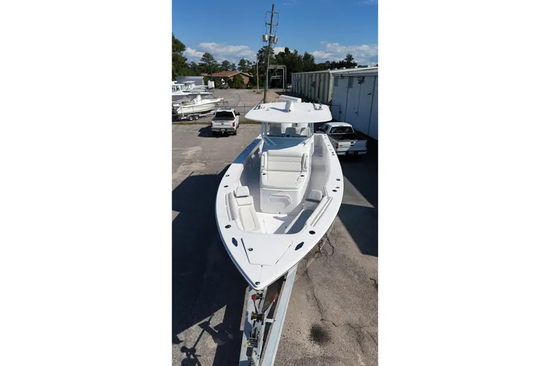 Slide: The Image of 2023 Jupiter 40 boat on trailer in outdoor storage area. - 13
