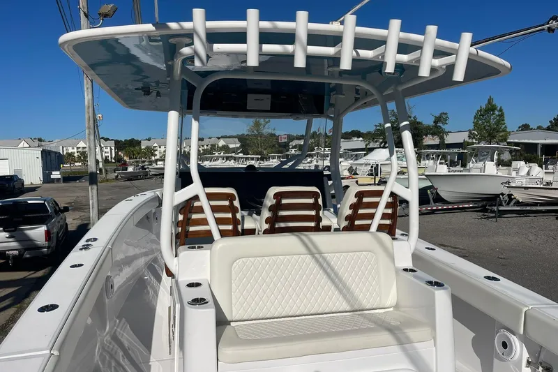 Slide: The Image of 2023 Jupiter 40 boat with seating and rod holders, docked in a marina. - 15