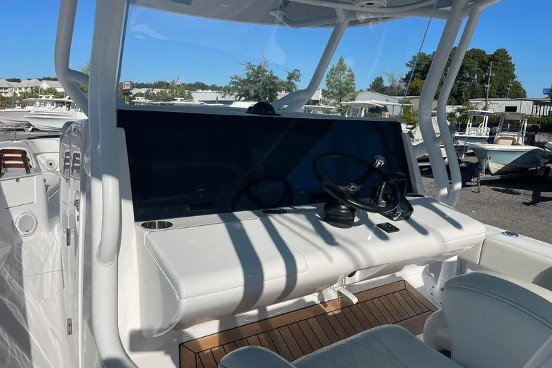 Slide: The Image of 2023 Jupiter 40 boat helm with steering wheel and control panel. - 17