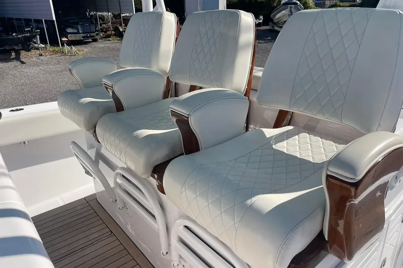 Slide: The Image of Luxurious seating on 2023 Jupiter 40 boat with diamond-stitched upholstery and wooden accents. - 18