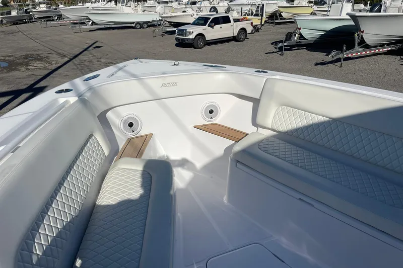 Slide: The Image of 2023 Jupiter 40 boat interior with white quilted seating and wood accents. - 20
