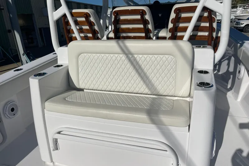 Slide: The Image of 2023 Jupiter 40 boat interior with white cushioned seating and cup holders. - 30