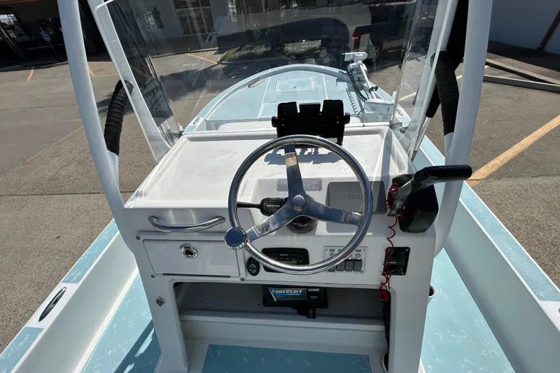 Slide: The Image of 2016 Shallow Sport 21 Sport boat console with steering wheel and controls. - 12