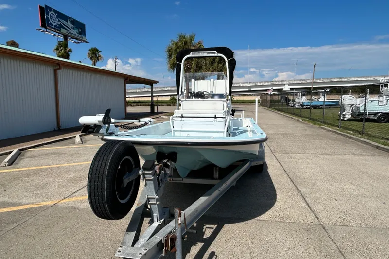 Slide: The Image of 2016 Shallow Sport 21 Sport boat on trailer in sunny outdoor setting. - 3