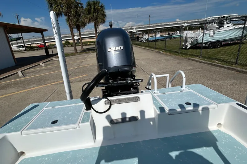 Slide: The Image of 2016 Shallow Sport 21 Sport boat with Yamaha 200 engine in a parking area. - 8
