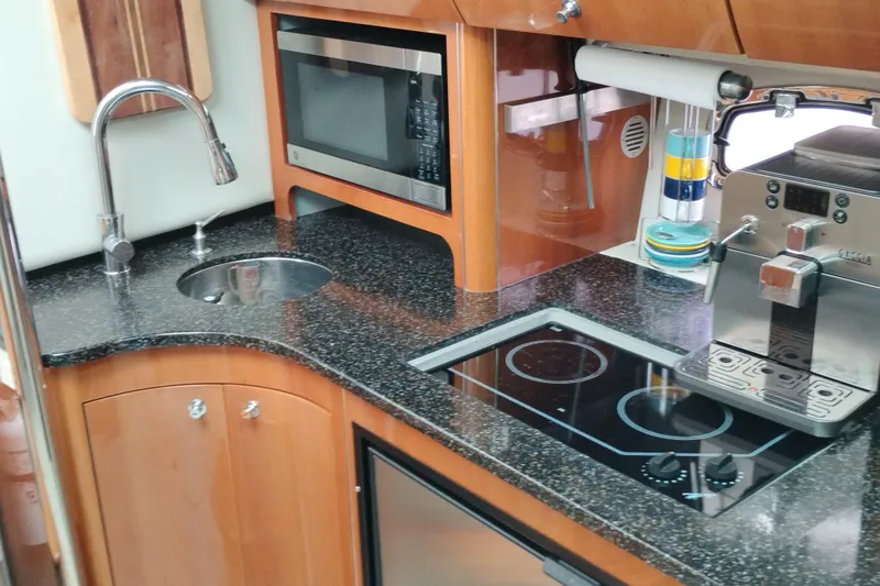 Slide: The Image of Luxurious 2007 Doral 40 MEDITERRA yacht kitchen with modern appliances and sleek countertops. - 14