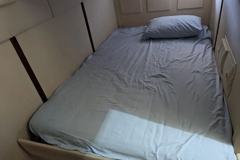 Slide: The Image of Small bed with blue sheets inside a 2007 Doral 40 MEDITERRA boat cabin. - 20