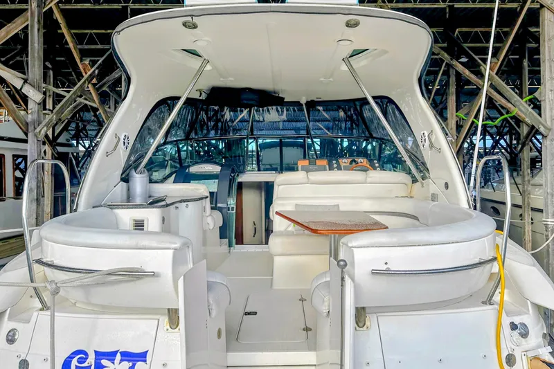 Slide: The Image of 2007 Doral 40 MEDITERRA yacht interior with white seating and wooden table. - 4