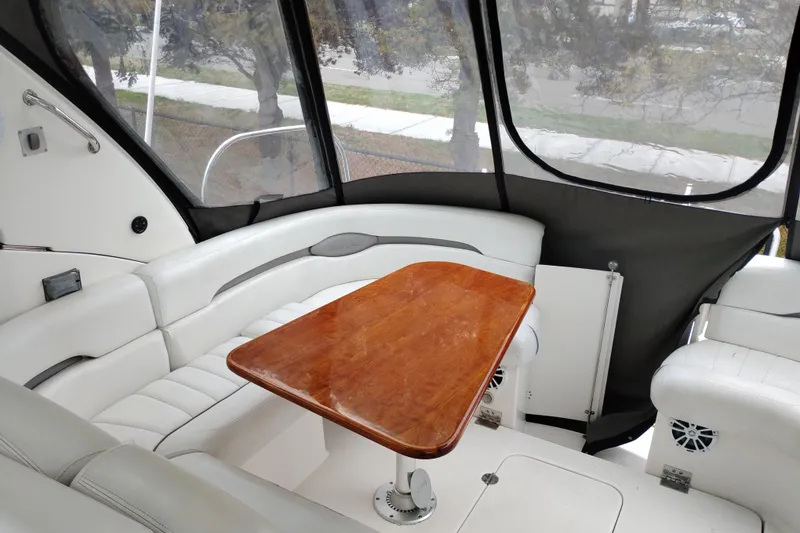 Slide: The Image of Interior of 2007 Doral 40 MEDITERRA yacht with white seating and wooden table. - 8