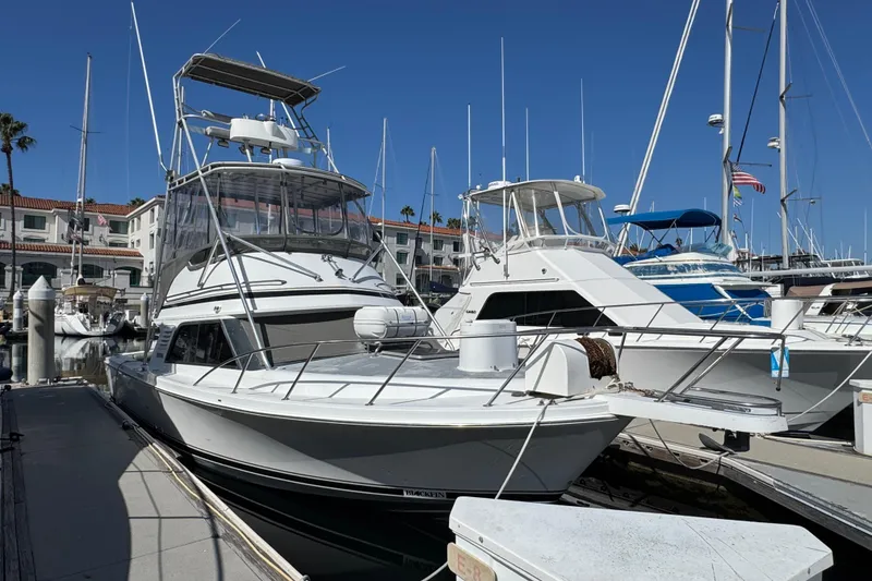 The Image of 1993 Blackfin Sportfisher boat docked at a marina under clear blue skies. - 0