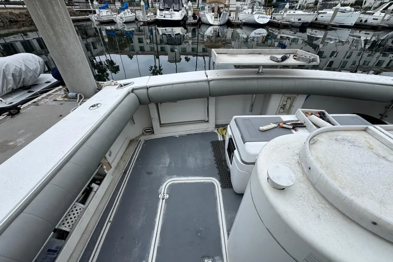 Slide: The Image of 1993 Blackfin Sportfisher boat deck with fishing gear, docked at marina. - 10