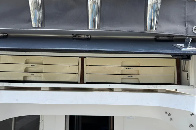 Slide: The Image of Storage drawers on a 1993 Blackfin Sportfisher boat, labeled for fishing gear. - 12