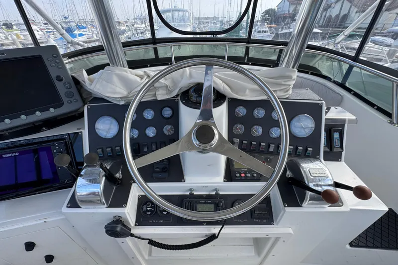 Slide: The Image of 1993 Blackfin Sportfisher helm with steering wheel, gauges, and navigation equipment. - 17
