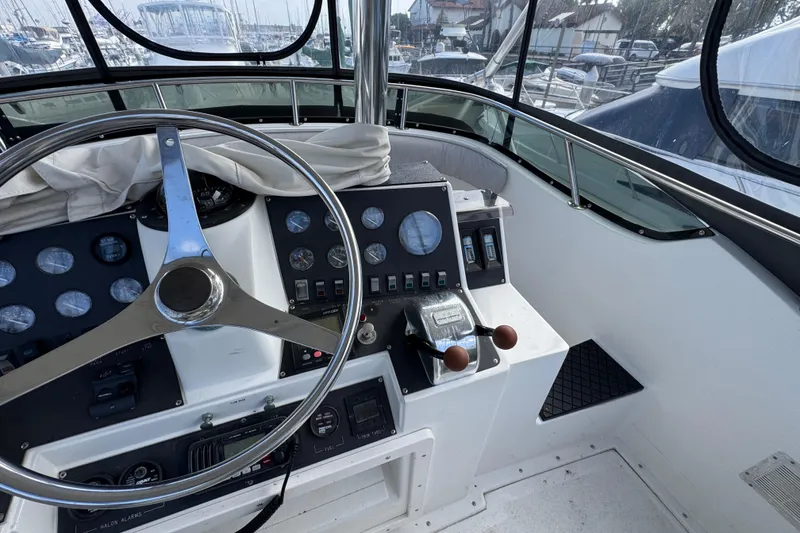 Slide: The Image of 1993 Blackfin Sportfisher helm with steering wheel and control panel, docked at marina. - 18