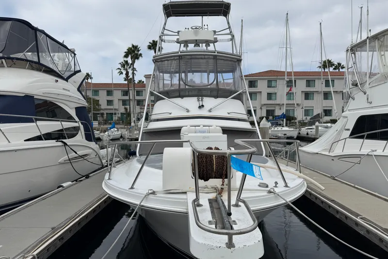Slide: The Image of 1993 Blackfin Sportfisher boat docked at marina with surrounding yachts. - 2