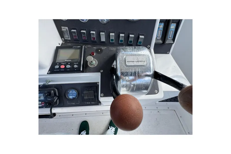 Slide: The Image of 1993 Blackfin Sportfisher control panel with throttle and navigation instruments. - 20