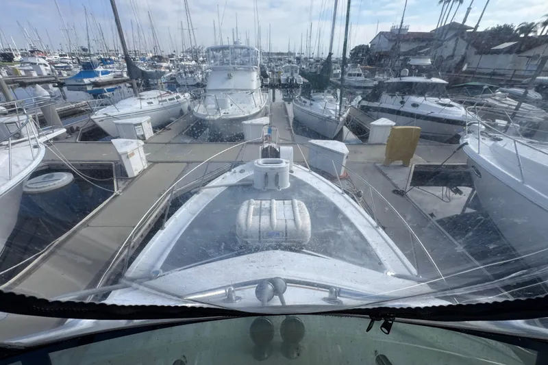 Slide: The Image of 1993 Blackfin Sportfisher docked in a crowded marina, surrounded by various boats. - 26