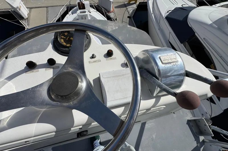 Slide: The Image of 1993 Blackfin Sportfisher helm with steering wheel and throttle controls. - 30