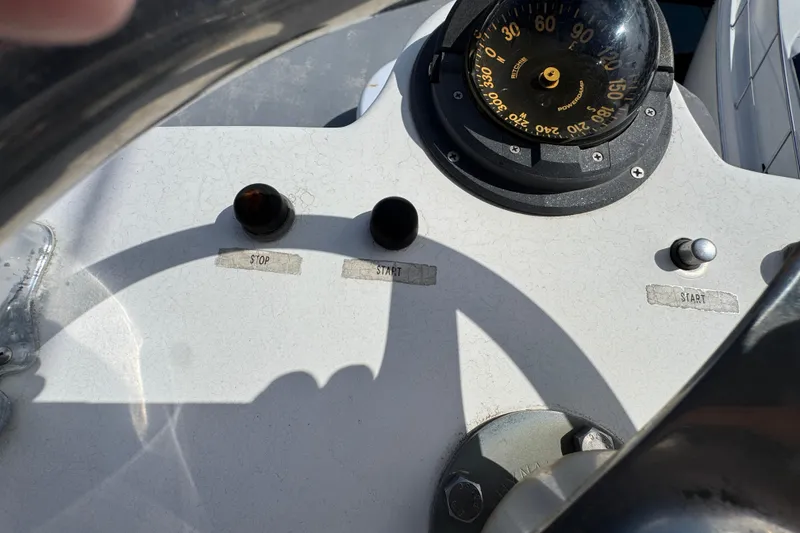Slide: The Image of 1993 Blackfin Sportfisher dashboard with compass, start, and stop buttons. - 31