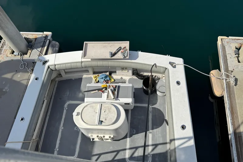 Slide: The Image of 1993 Blackfin Sportfisher boat deck with fishing gear, docked at marina. - 35