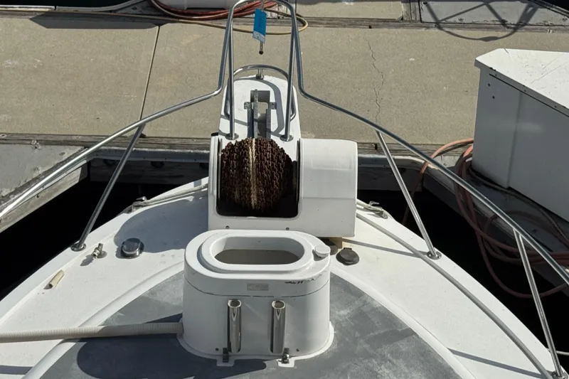 Slide: The Image of 1993 Blackfin Sportfisher boat deck with anchor chain and railing at dock. - 37