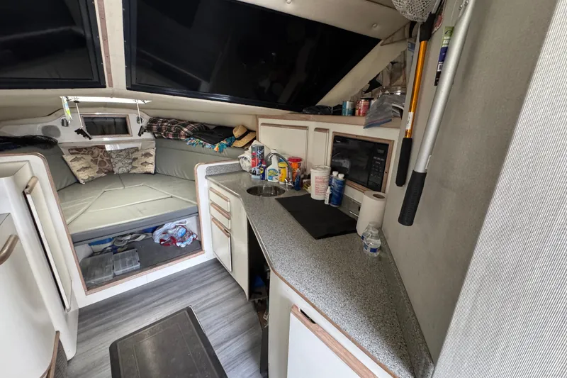 Slide: The Image of Interior of a 1993 Blackfin Sportfisher boat with kitchenette and cozy sleeping area. - 38