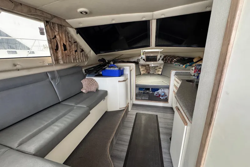 Slide: The Image of Interior of a 1993 Blackfin Sportfisher boat with seating and storage areas. - 40