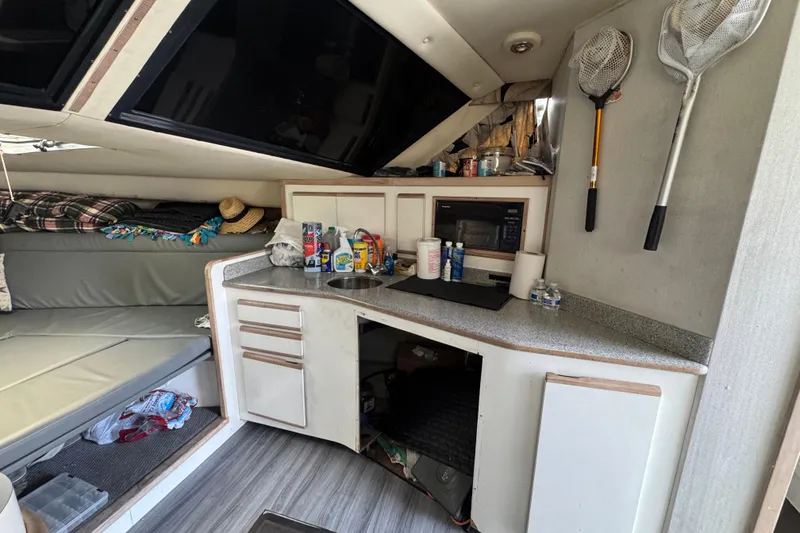 Slide: The Image of 1993 Blackfin Sportfisher interior with kitchenette, fishing nets, and seating area. - 41