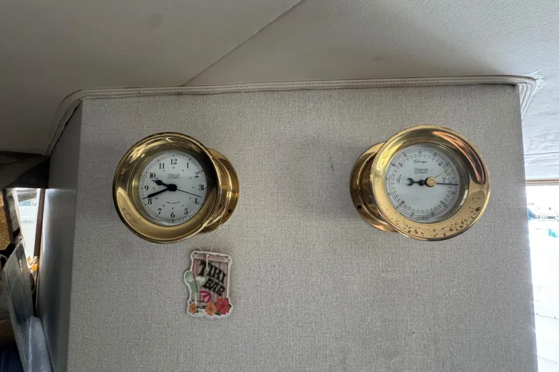 Slide: The Image of Brass clock and barometer on 1993 Blackfin Sportfisher boat interior wall. - 43