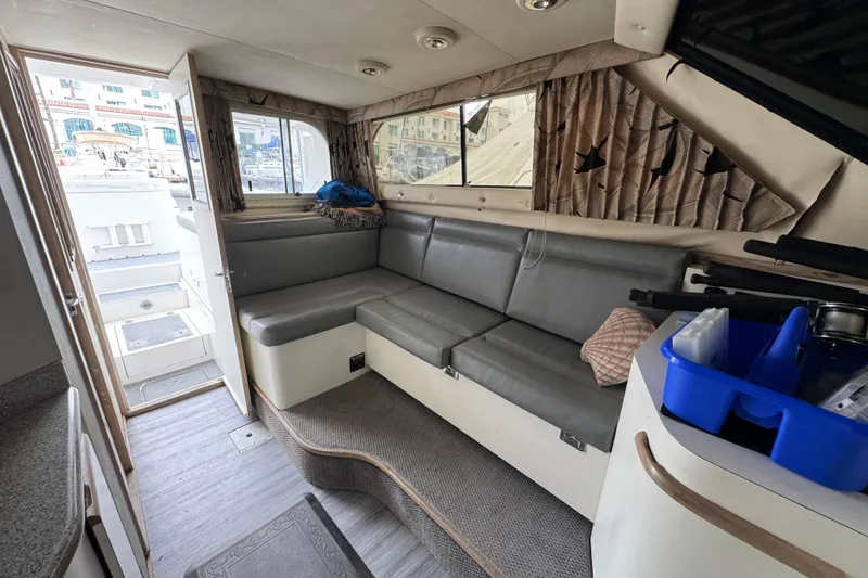 Slide: The Image of Interior of a 1993 Blackfin Sportfisher boat with gray seating and nautical decor. - 44