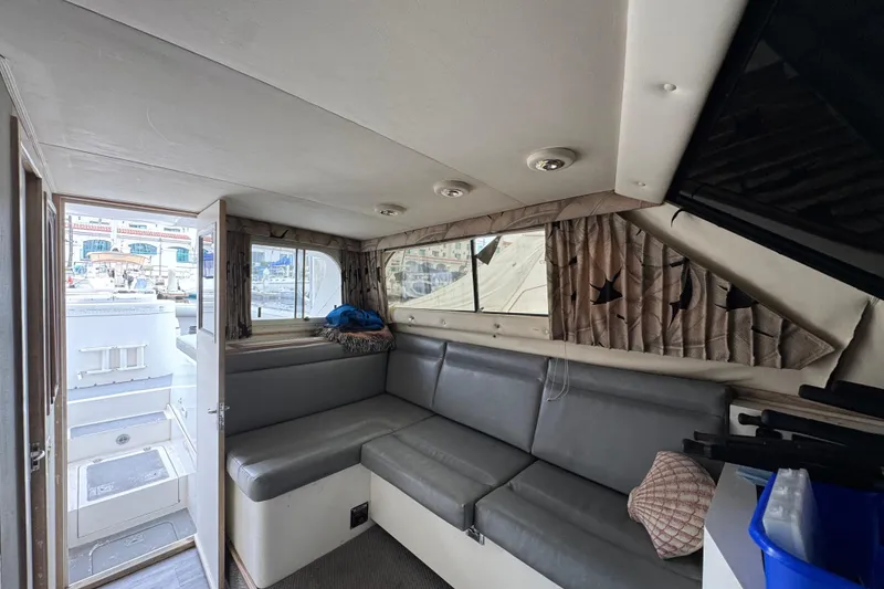 Slide: The Image of Interior of 1993 Blackfin Sportfisher boat with gray seating and nautical decor. - 45