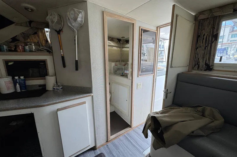 Slide: The Image of Interior of a 1993 Blackfin Sportfisher boat with fishing nets and seating area. - 47