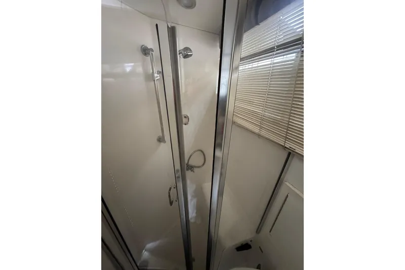 Slide: The Image of Shower area in 1993 Blackfin Sportfisher boat with glass door and blinds. - 50