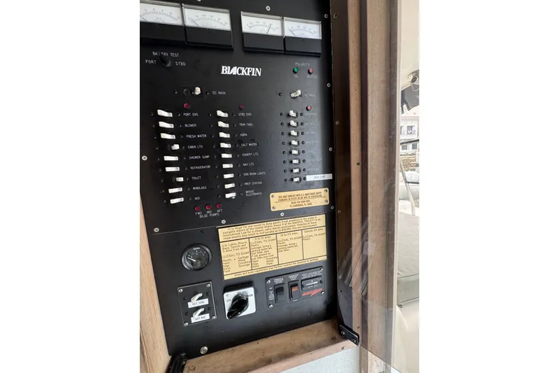 Slide: The Image of 1993 Blackfin Sportfisher control panel with switches and gauges. - 52