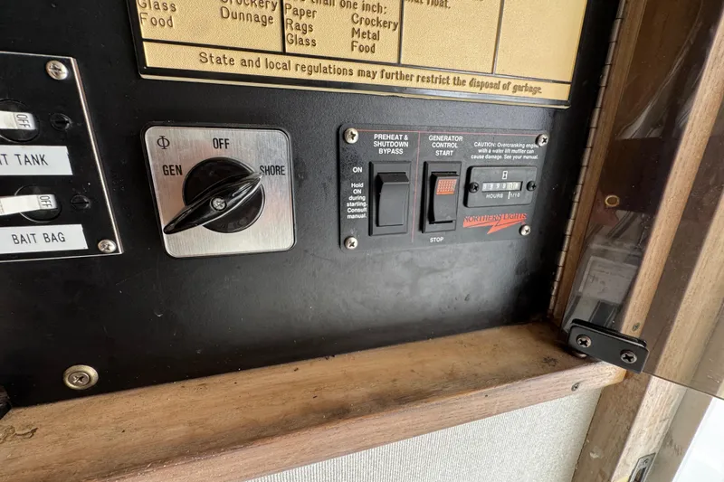 Slide: The Image of 1993 Blackfin Sportfisher control panel with generator and shore power switches. - 53