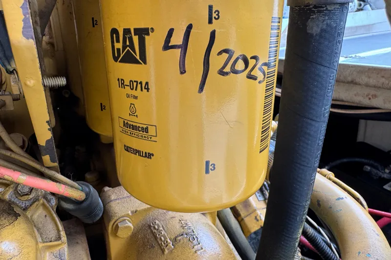 Slide: The Image of Caterpillar oil filter on 1993 Blackfin Sportfisher engine, marked "4/2025" for maintenance. - 55