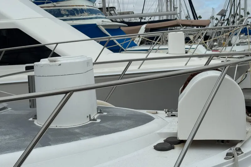 Slide: The Image of 1993 Blackfin Sportfisher boat docked in a marina, surrounded by other vessels. - 6